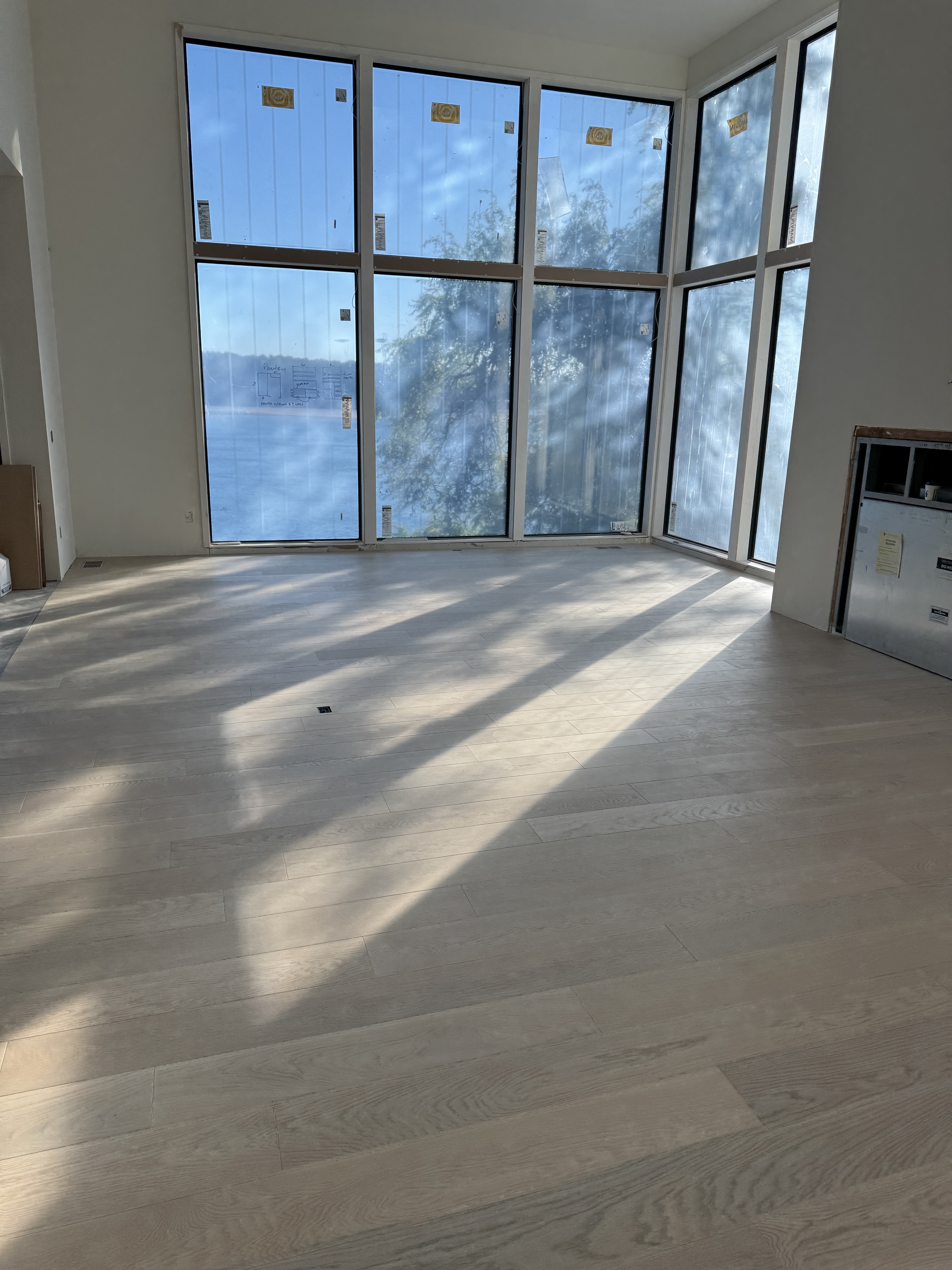 Wide shot of large space with light flooring and tall ceilings